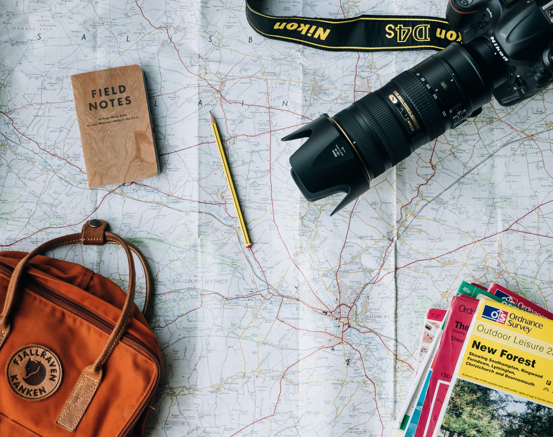 Travel planning essentials arranged on a map
